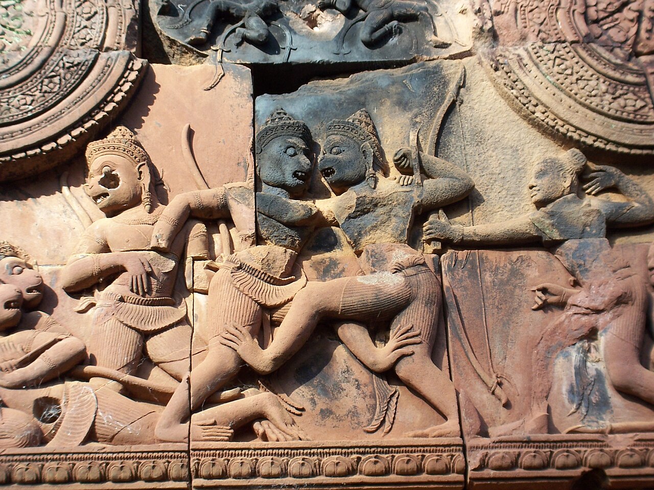 An old stone carving showing fighters in an ancient martial art.