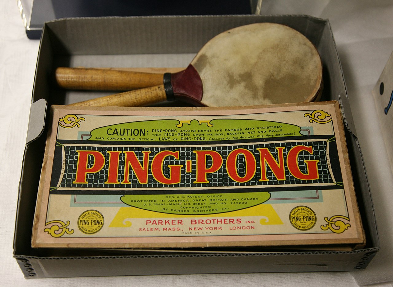 A vintage table tennis game set with paddles and a small ball.